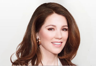 naomi whittel with long brown hair and earrings against a white background